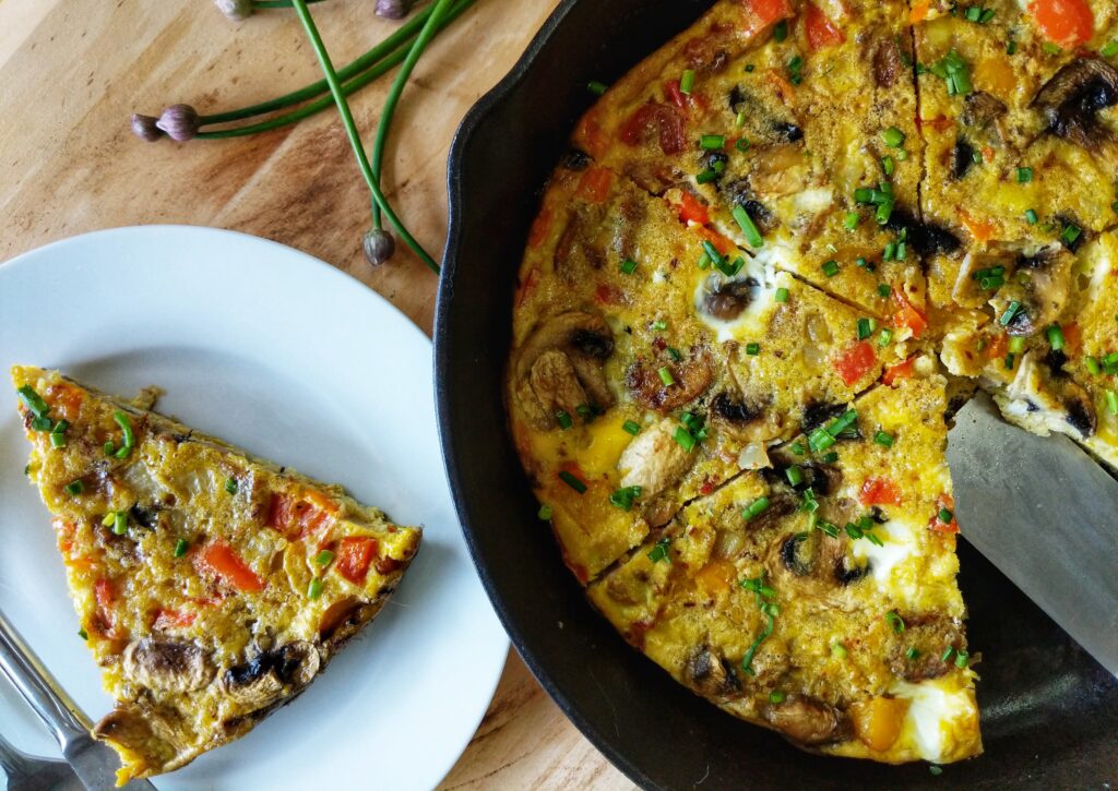 Presented on a white plate is a slice of Whole30 Italian Sausage Frittata loaded with flavorful Italian sausage and a healthy blend of vegetables.